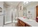 Modern bathroom featuring a glass-enclosed shower, a vanity with a sink, and neutral tones at 7700 W Grand Ave, Littleton, CO 80123