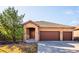 Charming home with a three car garage, stone accents, a tiled roof, and lovely curb appeal at 7700 W Grand Ave, Littleton, CO 80123