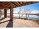 Stunning view of the lake from the covered brick patio offers the perfect setting for outdoor enjoyment at 7700 W Grand Ave, Littleton, CO 80123