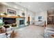 Living room features a fireplace, large television, and views of an upper landing at 7700 W Grand Ave, Littleton, CO 80123