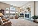 Spacious living room featuring high ceilings, fireplace, and large picture windows at 7700 W Grand Ave, Littleton, CO 80123