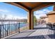 Covered deck with wrought iron railing and a view of the lake at 7700 W Grand Ave, Littleton, CO 80123