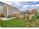 Backyard with green lawn, picket fence, and stone pathway to the door at 1137 Hummingbird Cir, Longmont, CO 80501