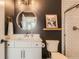 Contemporary bathroom featuring white cabinets, quartz counters, and brushed gold fixtures at 1137 Hummingbird Cir, Longmont, CO 80501