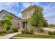 Attractive two-story home with low maintenance front yard landscaping with a stone base and walkway at 1137 Hummingbird Cir, Longmont, CO 80501