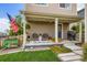 Inviting front porch with chairs, string lights, and American flag at 1137 Hummingbird Cir, Longmont, CO 80501