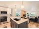 Modern kitchen featuring an island, stainless appliances, and an open layout to the living area at 1137 Hummingbird Cir, Longmont, CO 80501