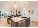 Modern kitchen with an island, stainless steel appliances, and an open layout to the dining and living areas at 1137 Hummingbird Cir, Longmont, CO 80501