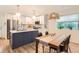 Contemporary kitchen featuring a large center island, stainless steel appliances, and dining area at 1137 Hummingbird Cir, Longmont, CO 80501