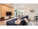 Inviting living room with a comfortable blue sectional, modern decor, and natural light at 1137 Hummingbird Cir, Longmont, CO 80501