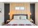 Comfortable main bedroom with unique wood paneling and modern lighting at 1137 Hummingbird Cir, Longmont, CO 80501