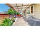 Covered back porch featuring outdoor seating, lighting, and a grill at 8774 Princeton St, Westminster, CO 80031