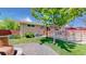 Backyard featuring a lawn, exterior of home, a covered porch, and wood fence at 8774 Princeton St, Westminster, CO 80031