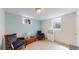 Basement seating area with hardwood floors, two comfortable chairs, and a window for a cozy ambiance at 8774 Princeton St, Westminster, CO 80031