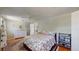 Comfortable bedroom showcasing hardwood floors, a decorative patterned comforter, and a dresser for a cozy ambiance at 8774 Princeton St, Westminster, CO 80031