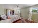 Bedroom with green walls, a large window, and a closet with bi-fold doors, providing ample storage space at 8774 Princeton St, Westminster, CO 80031
