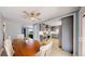 Open dining area featuring a wood table, tile floors, and a seamless transition into the adjacent updated kitchen at 8774 Princeton St, Westminster, CO 80031