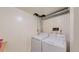 Laundry room with a white washer and dryer, utility connections and painted walls at 8774 Princeton St, Westminster, CO 80031