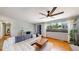 Bright living room featuring hardwood floors, a large window, and a comfortable couch, perfect for relaxation at 8774 Princeton St, Westminster, CO 80031