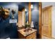 Charming powder room with custom vanity, decorative fixtures, and rustic wooden accents at 4446 Songbird Ln, Evergreen, CO 80439