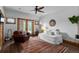 Bright bedroom with wood accents, a ceiling fan, cozy seating, and an inviting rug at 4446 Songbird Ln, Evergreen, CO 80439