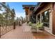 Expansive deck with seating, decorative railings, and stunning views at 4446 Songbird Ln, Evergreen, CO 80439