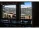 Inviting dining room featuring mountain views through large windows and rustic, elegant decor at 4446 Songbird Ln, Evergreen, CO 80439