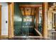 Grand foyer showcasing wood beams, custom railings, and beautiful chandelier at 4446 Songbird Ln, Evergreen, CO 80439