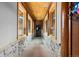 Inviting hallway with stone accents and natural light from large windows at 4446 Songbird Ln, Evergreen, CO 80439