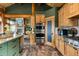 Kitchen area showcasing stainless steel appliances, cooktop and island, and wood cabinets at 4446 Songbird Ln, Evergreen, CO 80439