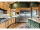 Kitchen featuring stainless steel appliances, tile backsplash, and wood cabinetry at 4446 Songbird Ln, Evergreen, CO 80439