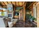 Cozy living room with a stone fireplace, hardwood floors, and comfortable seating at 4446 Songbird Ln, Evergreen, CO 80439