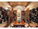 Charming wine cellar featuring custom racks and a tasting area with seating at 4446 Songbird Ln, Evergreen, CO 80439