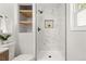 Modern shower with marble tile and built-in shelving at 287 Johnson Dr, Castle Rock, CO 80104