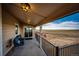 Enjoy scenic views from this relaxing covered back porch with comfortable seating and open countryside views at 4820 S County Road 137, Bennett, CO 80102