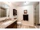 Bright bathroom with granite countertop vanity, shower, and cabinet at 4820 S County Road 137, Bennett, CO 80102