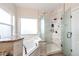Bright bathroom features a soaking tub, walk-in shower with glass door, and modern fixtures at 4820 S County Road 137, Bennett, CO 80102