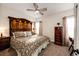 Bedroom featuring an oversized headboard, patterned bedding, two windows, and neutral-toned walls at 4820 S County Road 137, Bennett, CO 80102