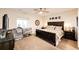 Bedroom featuring a crib, large bed, carpet floors, and a ceiling fan at 4820 S County Road 137, Bennett, CO 80102