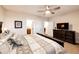 Bedroom with a large bed, a dresser with a TV, and access to the bathroom at 4820 S County Road 137, Bennett, CO 80102