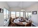 Light-filled dining room features a large round table, seating for eight, and views of the surrounding landscape at 4820 S County Road 137, Bennett, CO 80102