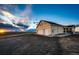 Scenic property featuring a lovely home, a spacious gravel driveway, and beautiful sunset horizon views at 4820 S County Road 137, Bennett, CO 80102