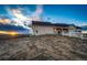 Picturesque home exterior with a sprawling lawn, a charming white fence, and breathtaking sunset views at 4820 S County Road 137, Bennett, CO 80102