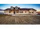 Inviting two-story home features dormer windows, a covered porch, and meticulous gravel landscaping at 4820 S County Road 137, Bennett, CO 80102