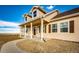 Charming front porch with wooden columns and stone landscaping details enhancing curb appeal at 4820 S County Road 137, Bennett, CO 80102