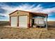 Spacious garage with covered parking for a trailer, and two garage doors at 4820 S County Road 137, Bennett, CO 80102