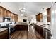 Spacious kitchen featuring wood cabinets, stainless steel appliances, granite counters, and an island with bar seating at 4820 S County Road 137, Bennett, CO 80102