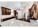 Charming kitchen features wood cabinets, granite countertops, stainless steel appliances, and updated light fixtures at 4820 S County Road 137, Bennett, CO 80102