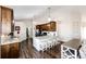 Bright kitchen features dark wood cabinets, granite countertops and modern stainless steel appliances at 4820 S County Road 137, Bennett, CO 80102
