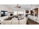 Comfortable living room with a fireplace, adjacent to the dining room and kitchen for seamless entertaining at 4820 S County Road 137, Bennett, CO 80102